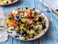 Salade de lentilles colorée avec tomates, concombre, poivrons, olives noires et feta. Un plat frais et savoureux.