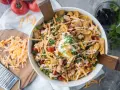 Salade Tex Mex généreuse avec poulet émietté, maïs, tomates cerises, fromage râpé, éclats de tortilla et une touche de crème. Parfait pour un repas plein de saveurs.